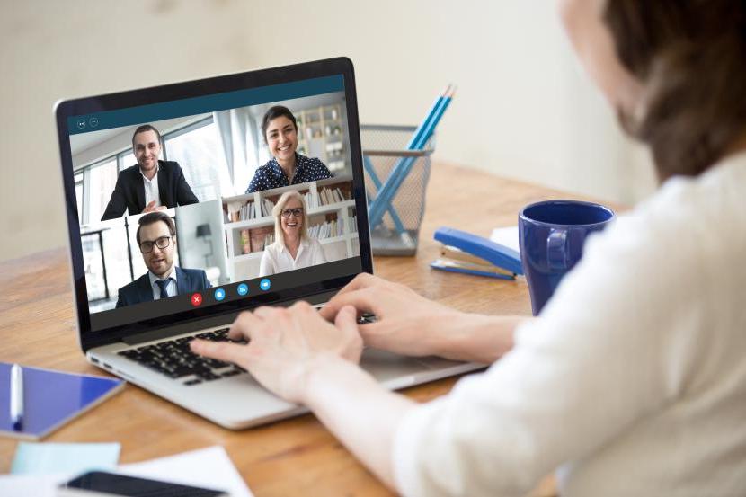 Woman working from home participating in group video call